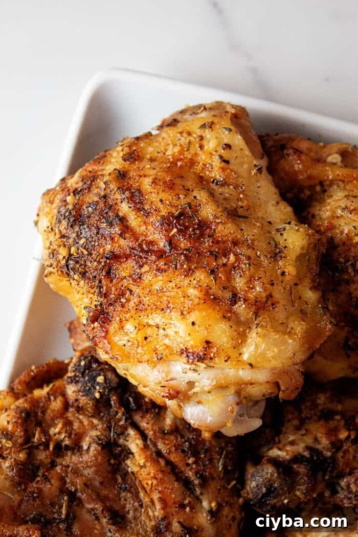 Keto Super Bowl Party Menu: Low-Carb Game Day Recipes 31 overhead view of ready to serve crispy air fryer garlic parmesan chicken thighs on a white plate