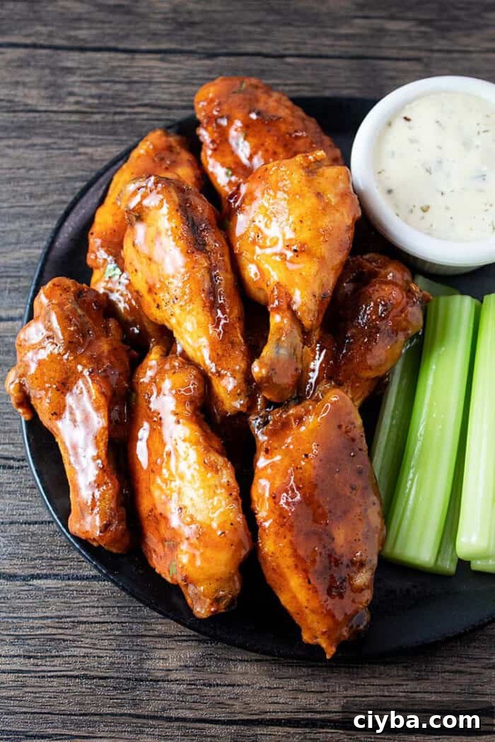 Keto Super Bowl Party Menu: Low-Carb Game Day Recipes 34 overhead view of air fryier buffalo hot wings on a black serving plate with celery and blue cheese on the side