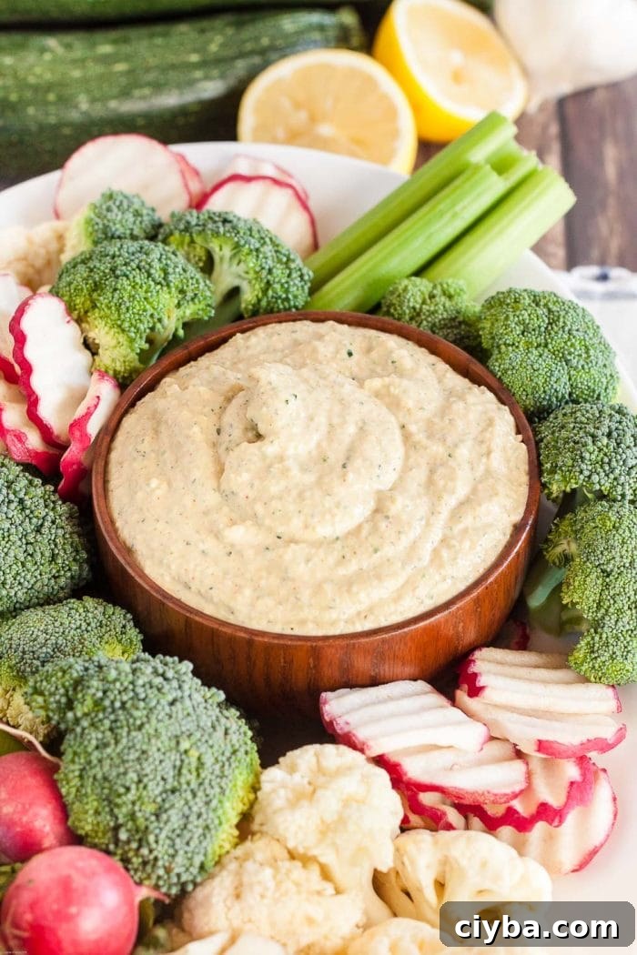 Keto Super Bowl Party Menu: Low-Carb Game Day Recipes 7 keto hummus in a bowl nestled inside of a large platter of keto fresh vegetables