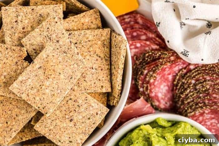 Keto Super Bowl Party Menu: Low-Carb Game Day Recipes 10 keto crackers in a bowl next to meats and cheeses