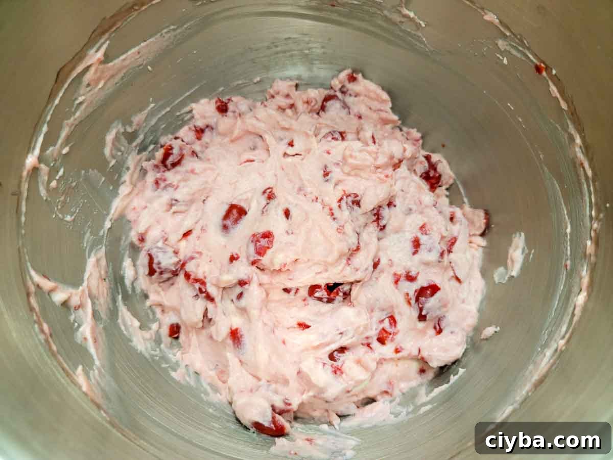 cherry cheesecake batter in a mixing bowl.
