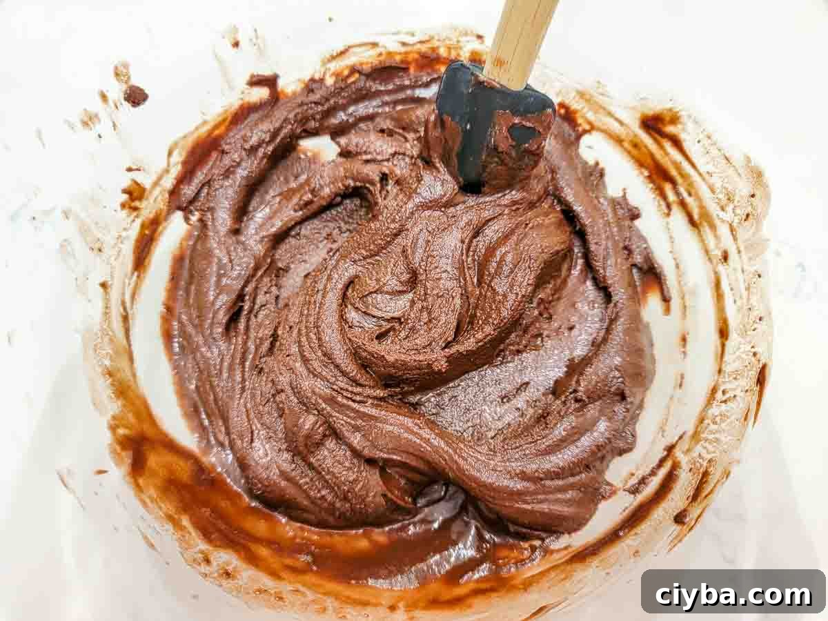 chocolate cheesecake batter in a mixing bowl.