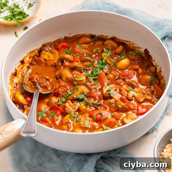 An image of cooked mushroom masala in a skillet.