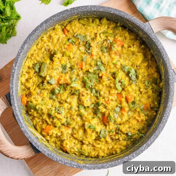 Overhead close up of cooked kitchari in a grey pot.