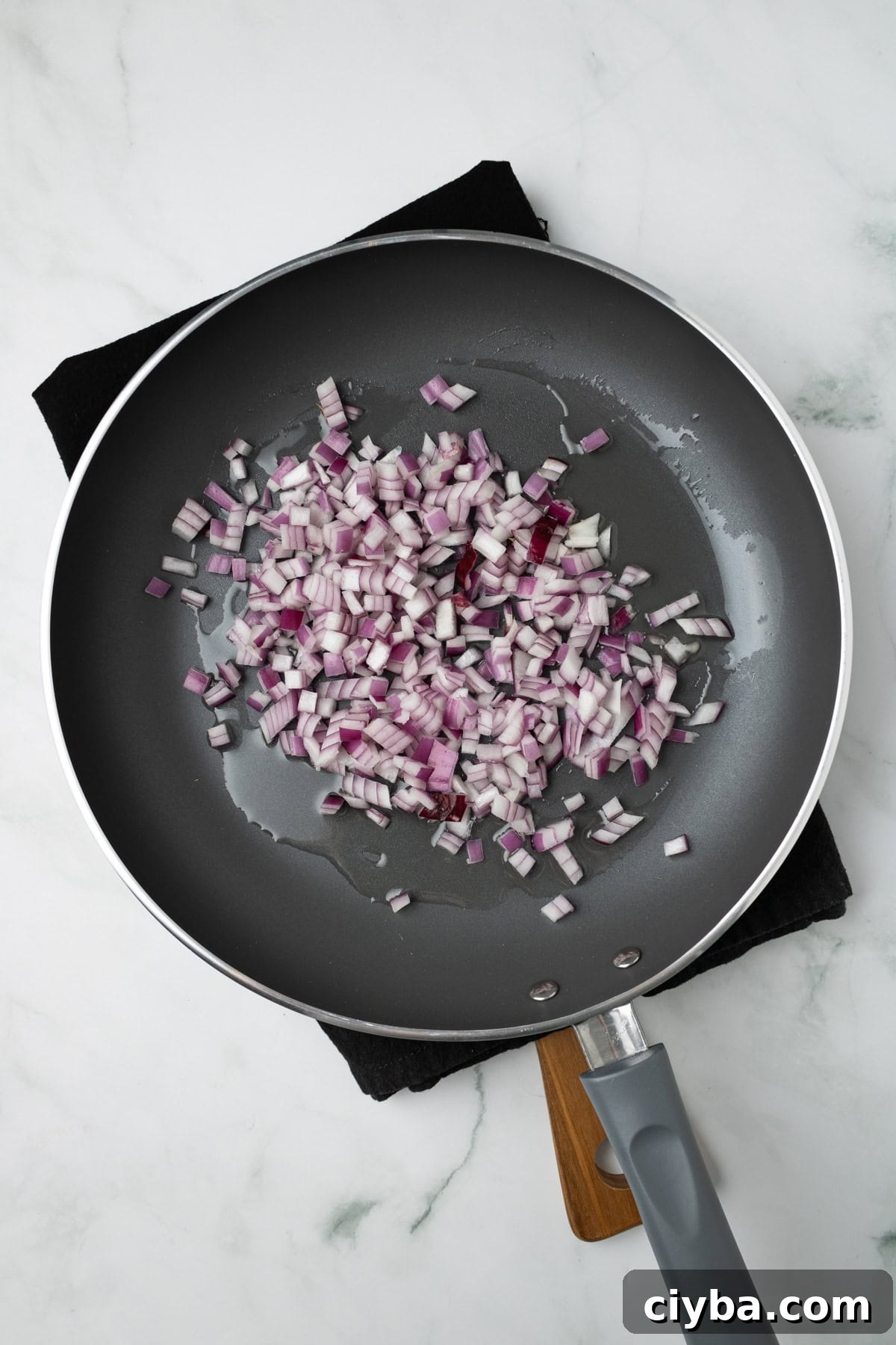 An overhead image of sauteing the onions in a pan.