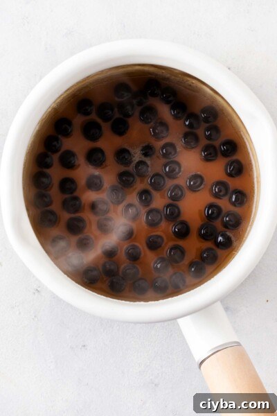 Tapioca pearls cooking in a pot.