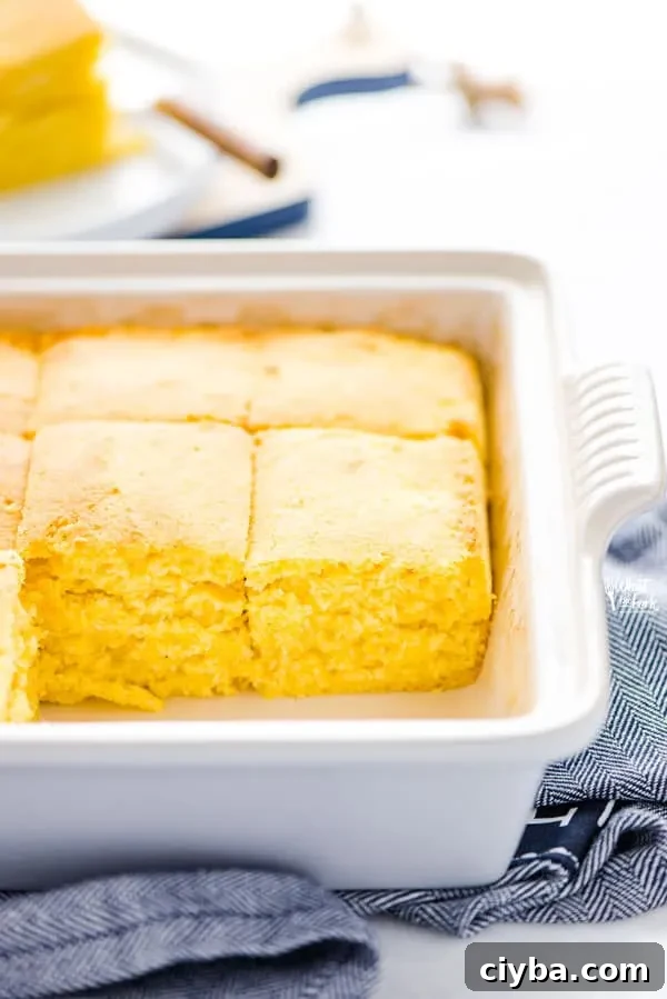 Gluten free sourdough cornbread sliced into squares in a baking dish.