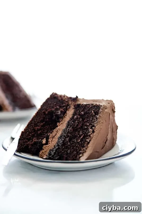 A slice of gluten free sourdough chocolate cake on a plate with a fork.