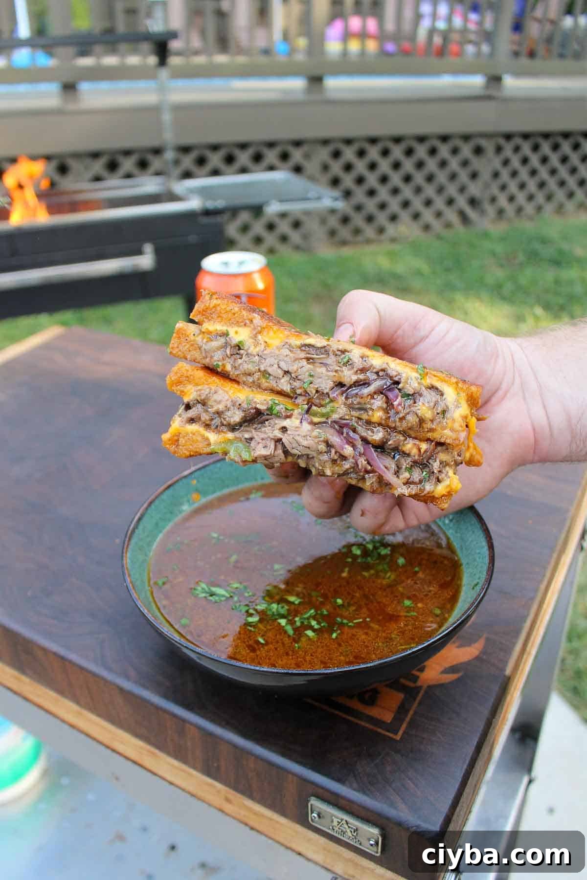 Beer-Braised Beef Melt is sliced in half and served with the braising sauce. 