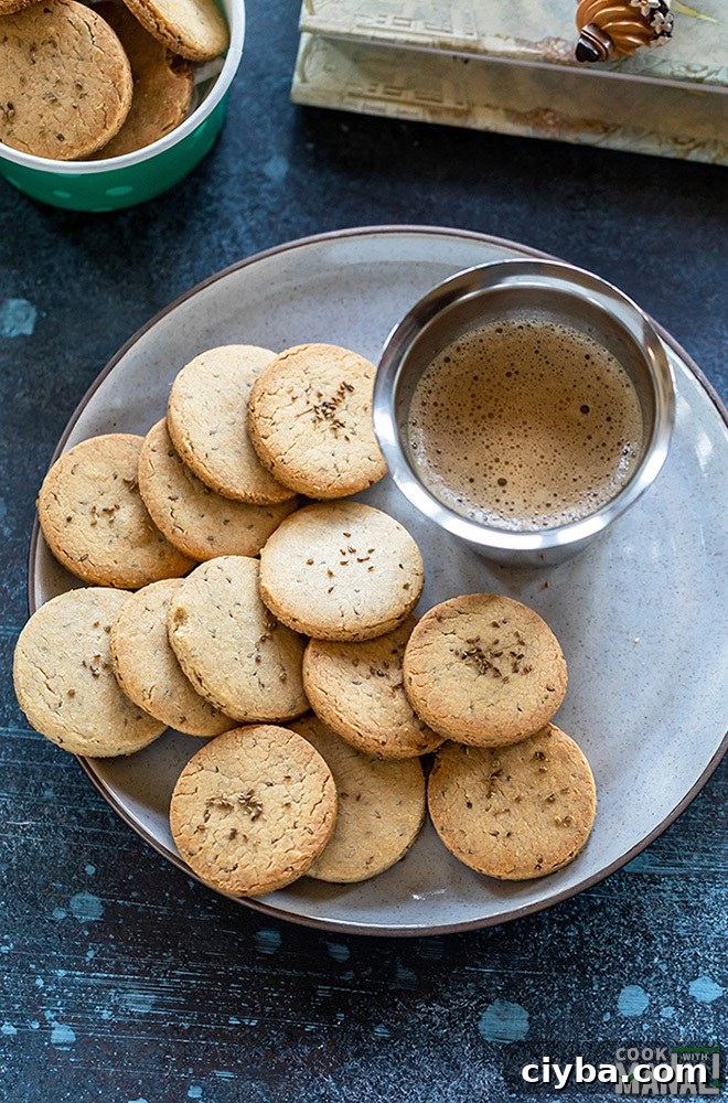 Savory Ajwain (Carom Seed) Cookies 5 overhead shot of ajwain biscuits in a plate with a glass of coffee