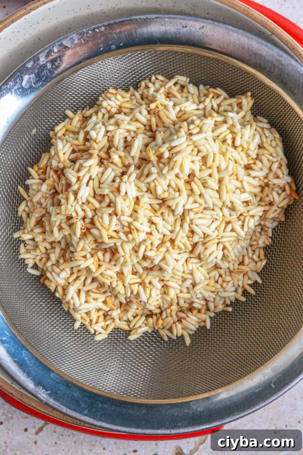 Place rice in a strainer and strain the oil