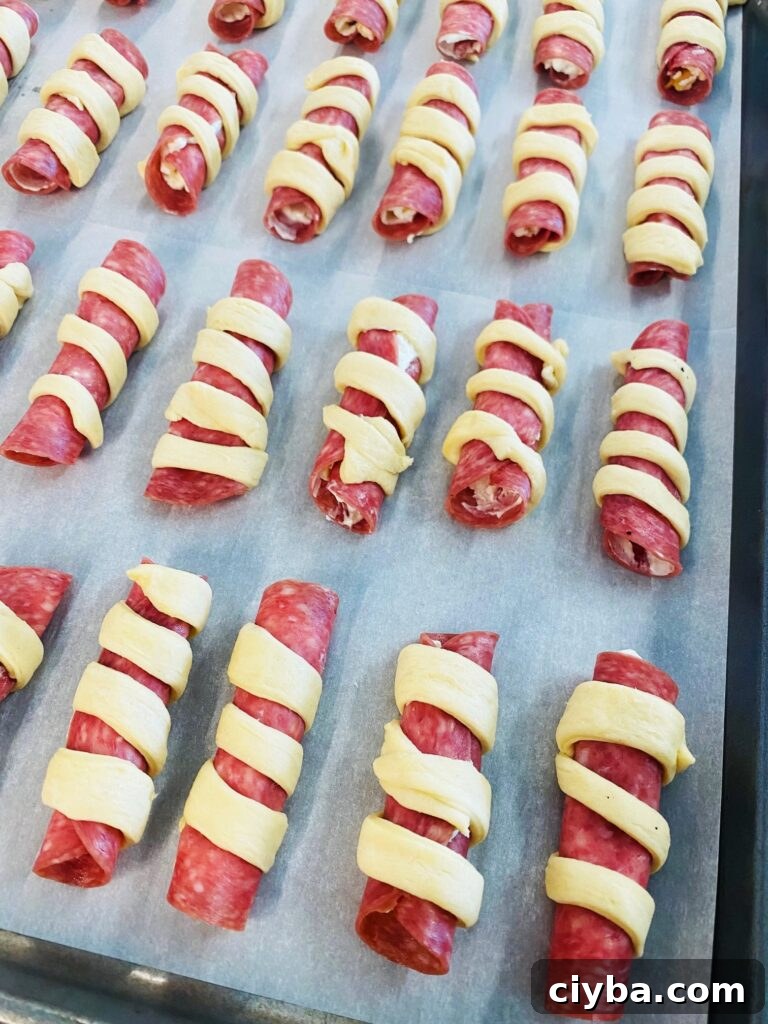 tray of uncooked salami rolls