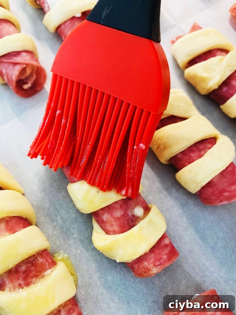 brushing the rolls with melted butter