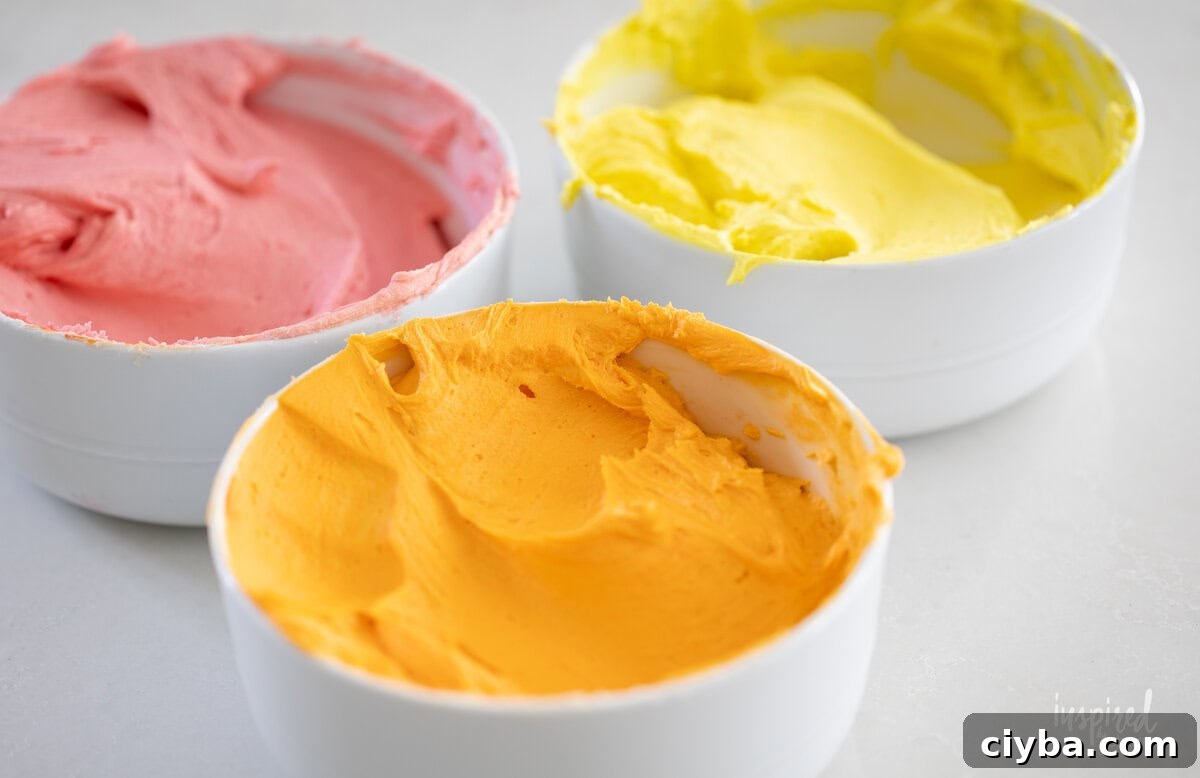 three bowls of colored frosting. 