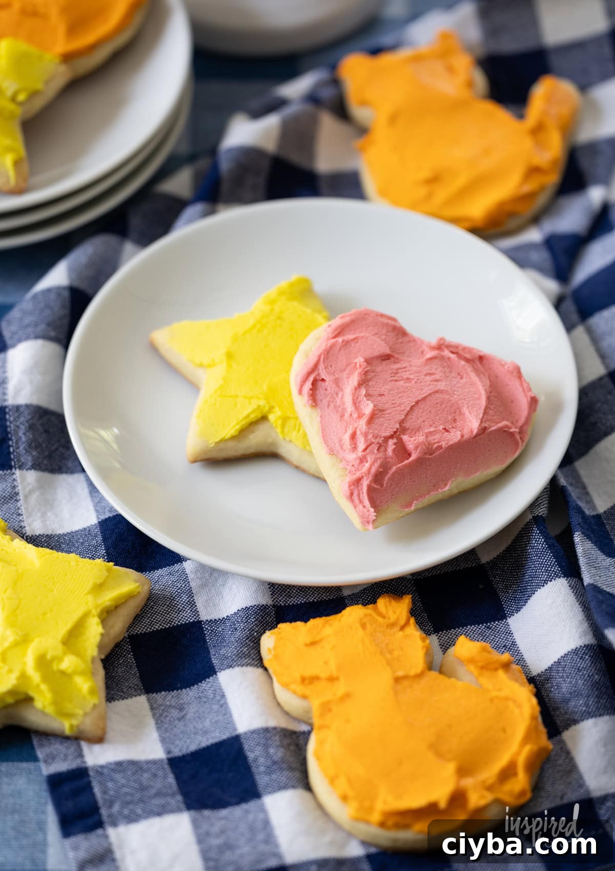 frosted sugar cookie on a table and on a small plate.