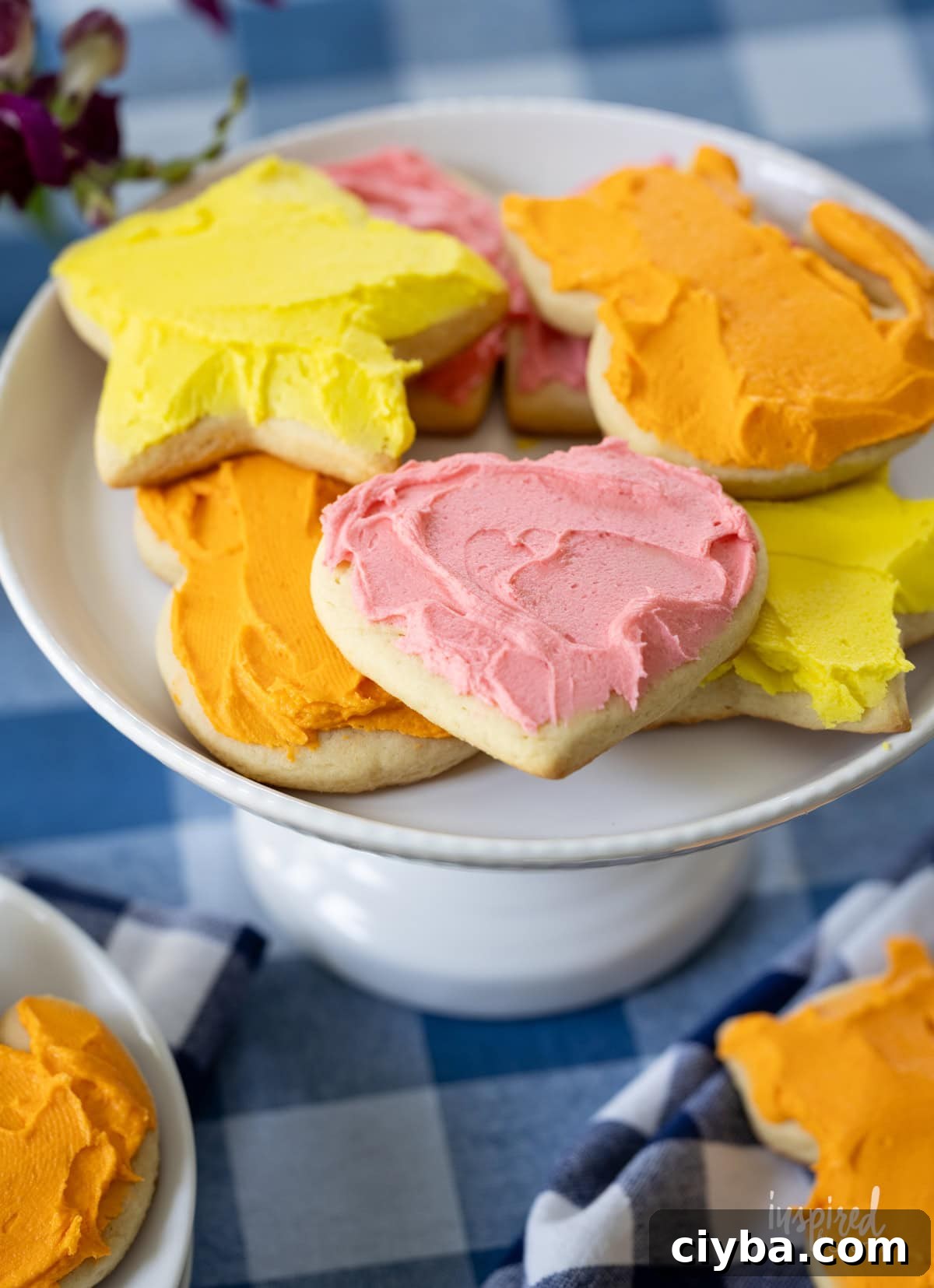 cake stand pilled with frosted sugar cookies.
