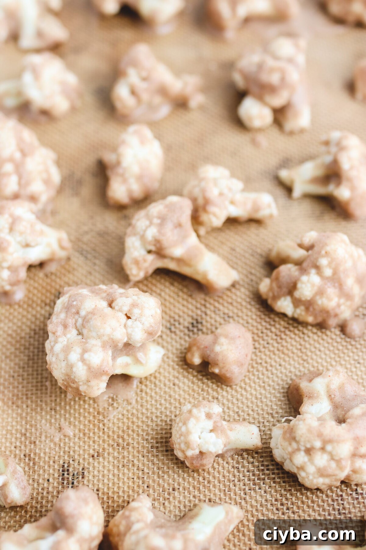 Crispy Vegan Buffalo Cauliflower Wings Recipe 4 cauliflower florets on a baking mat