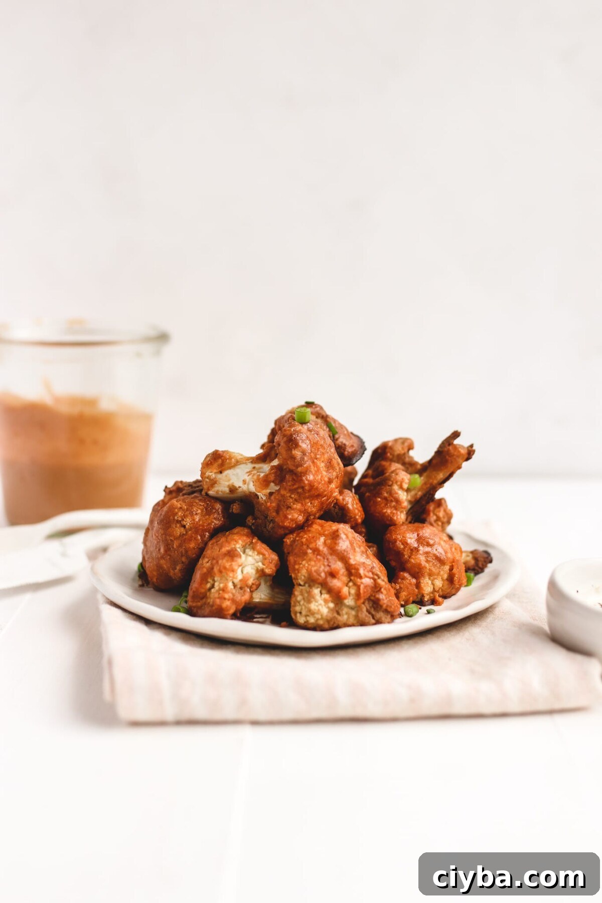 Crispy Vegan Buffalo Cauliflower Wings Recipe 6 a side view of cauliflower florets that have been baked with buffalo sauce