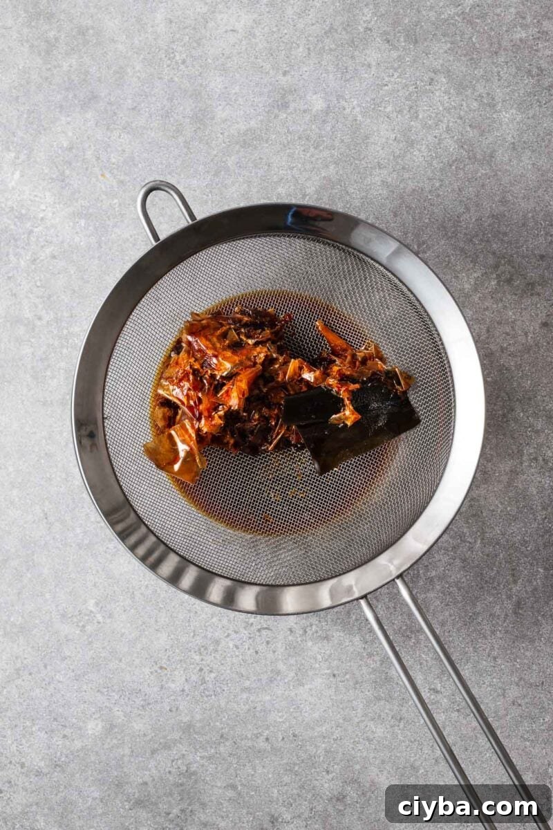 Kombu kelp and bonito flakes in a mesh sieve to strain off the mentsuyu.