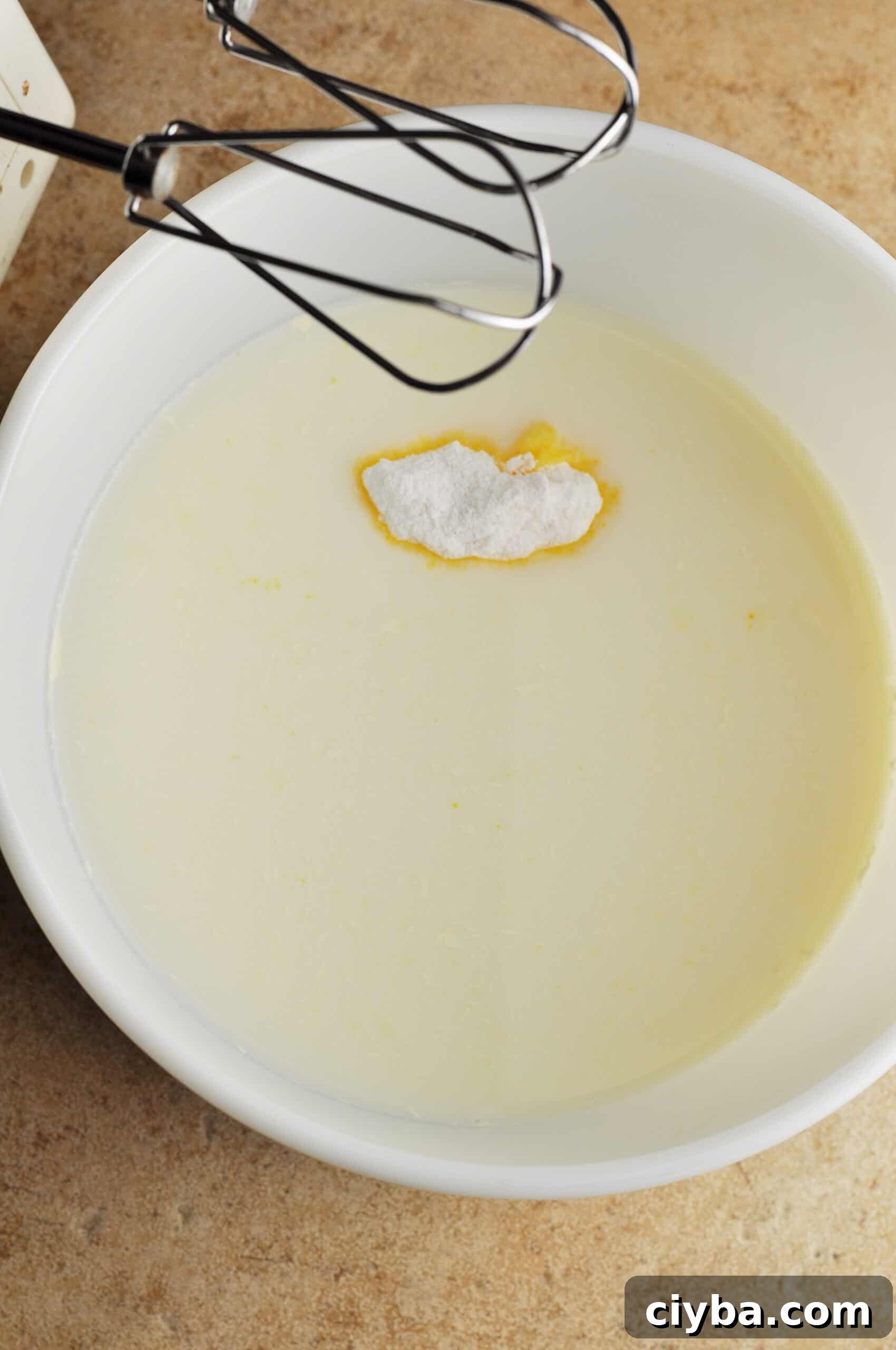 Mixing pudding and milk in a bowl