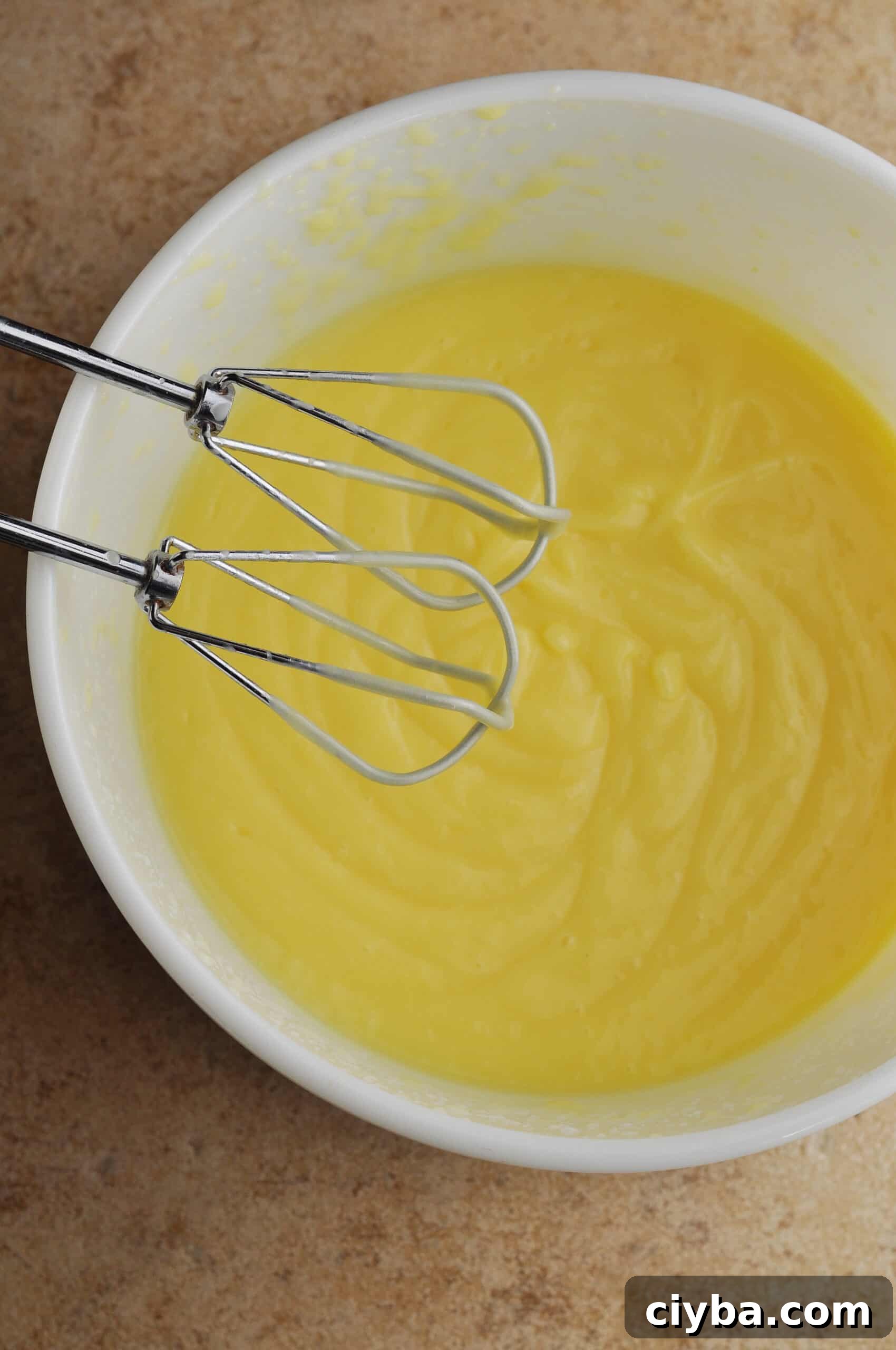 Whisking pudding mixture until thickened