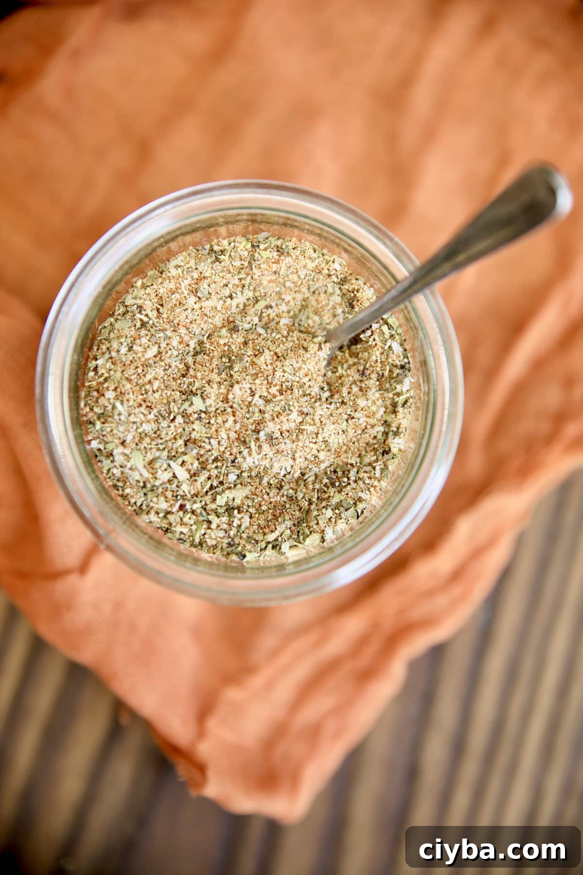 Overhead view of jar of spices with spoon.