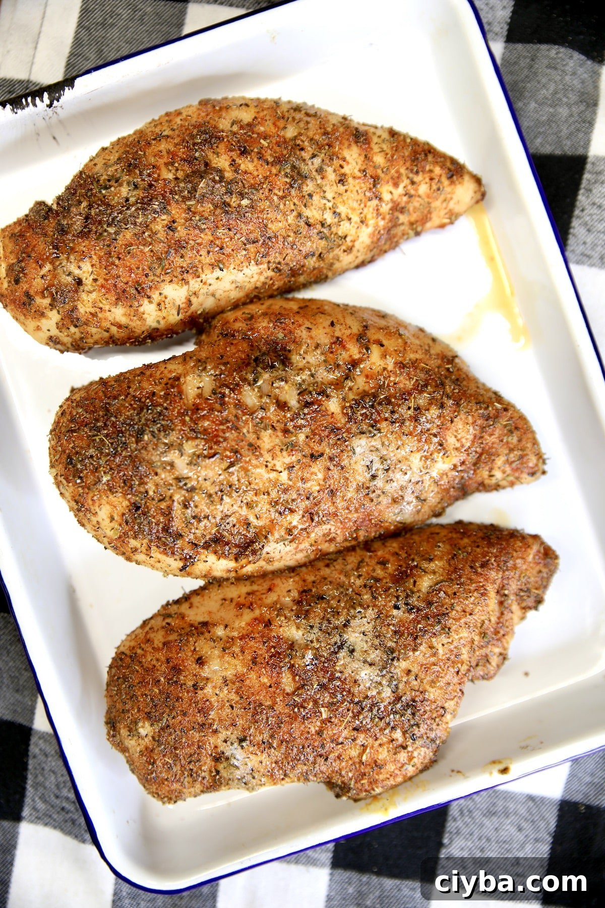 3 grilled chicken breasts on a platter.