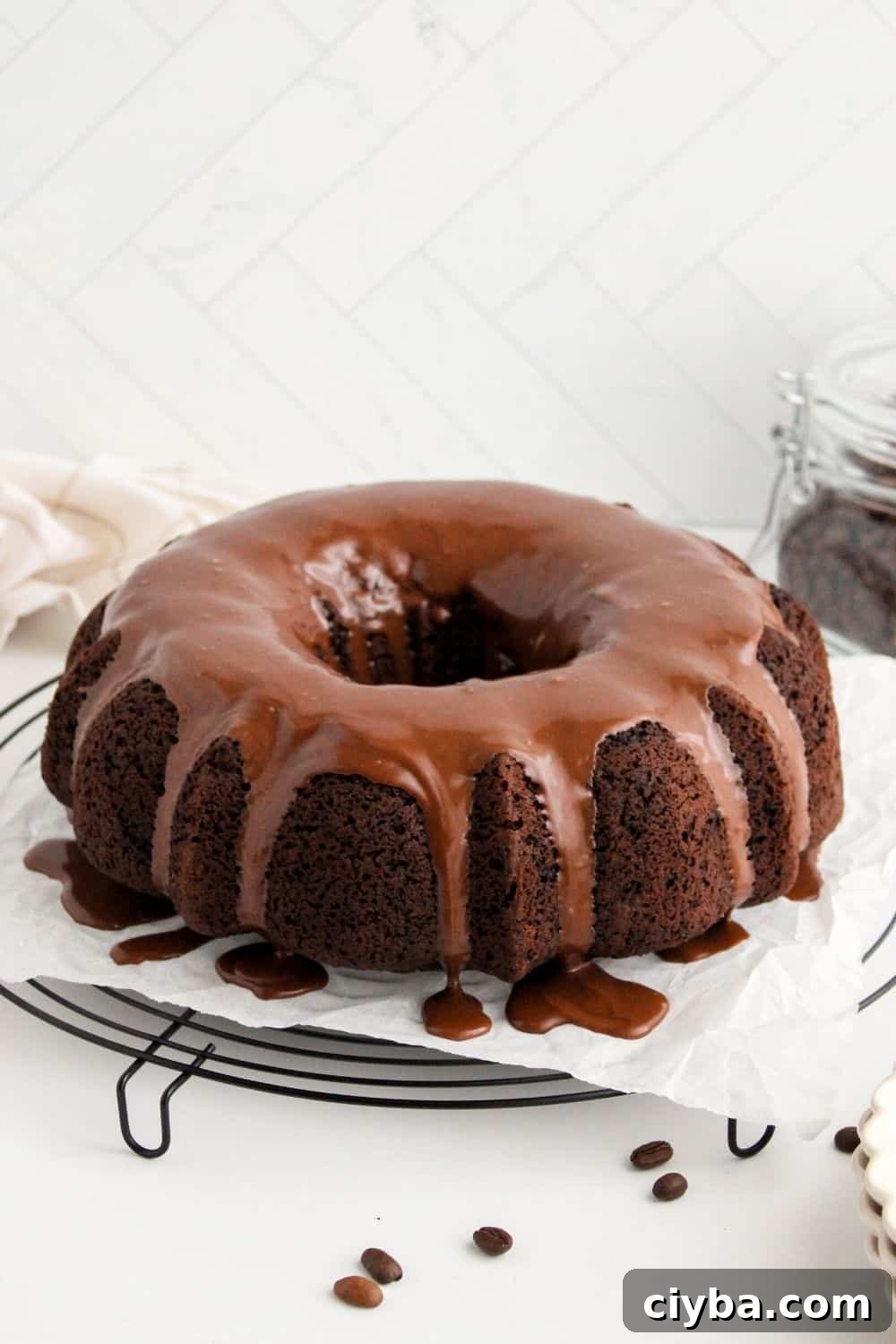 How to Make a Decadent Chocolate Fudge Cake 13 glazed chocolate fudge cake on a wire rack