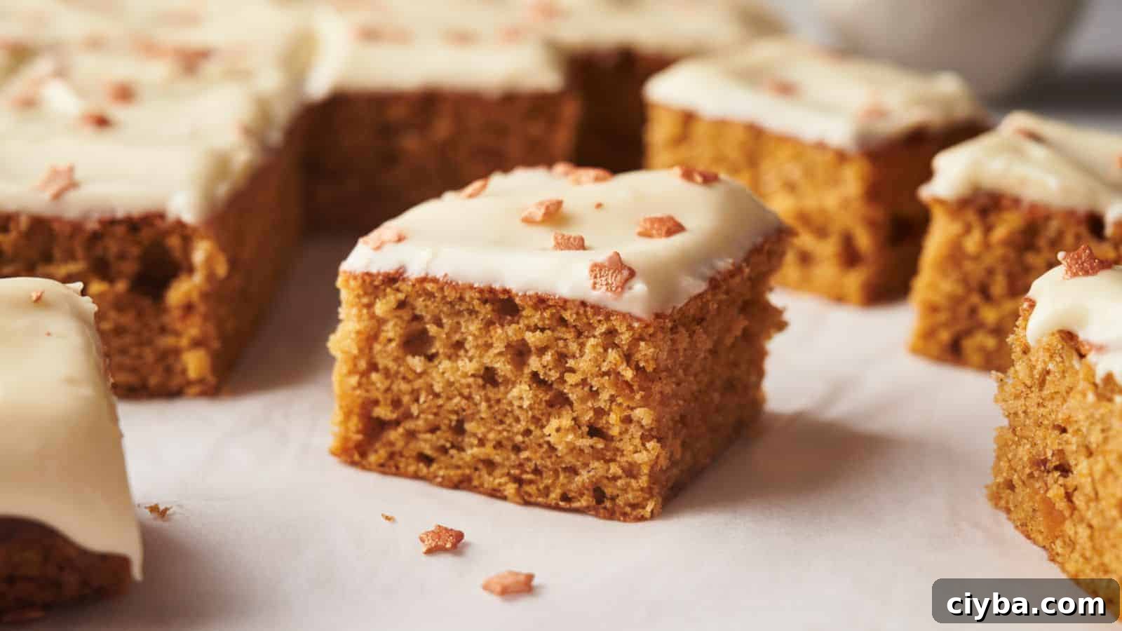 A group of pumpkin bars with icing on top.