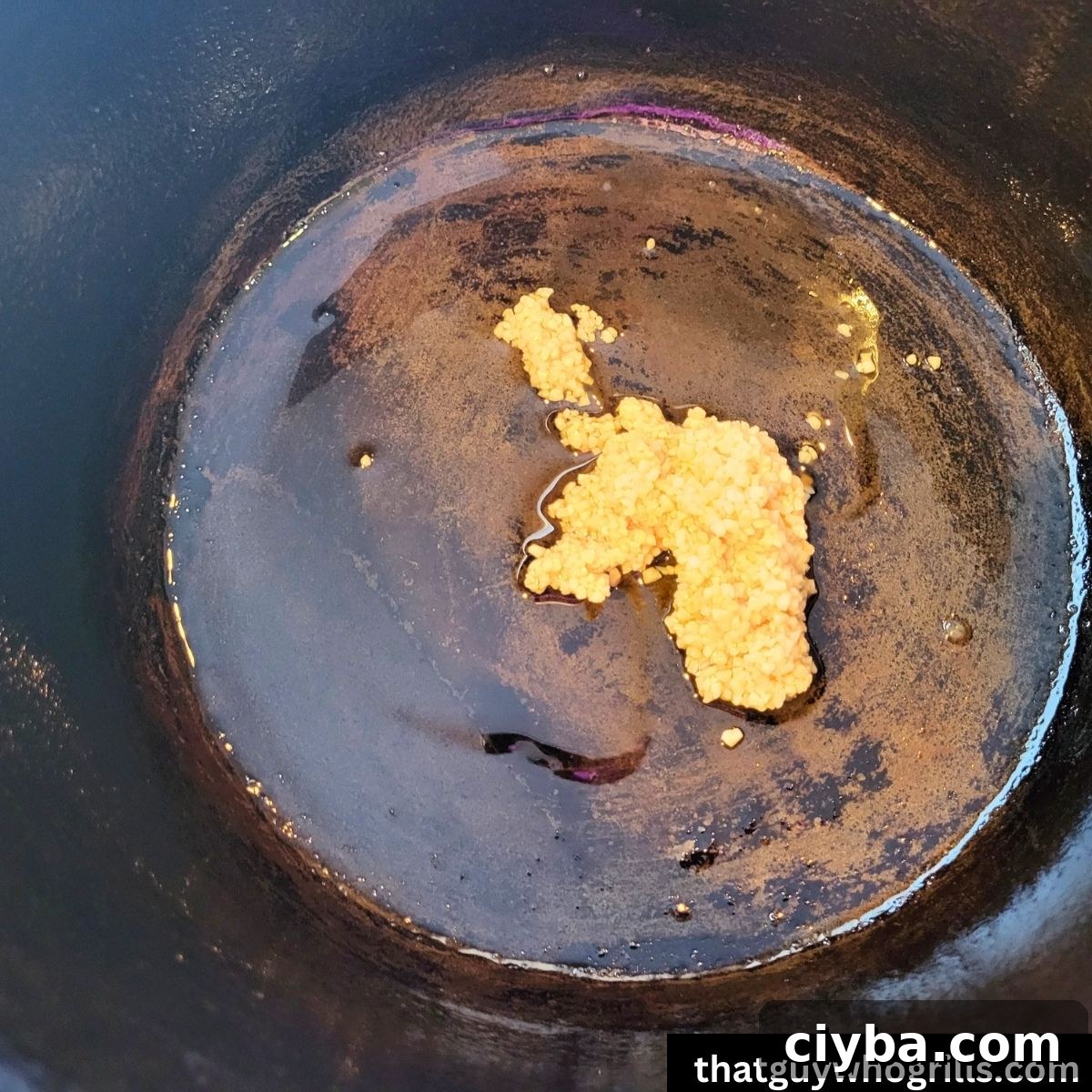Minced garlic in the bottom of a dutch oven