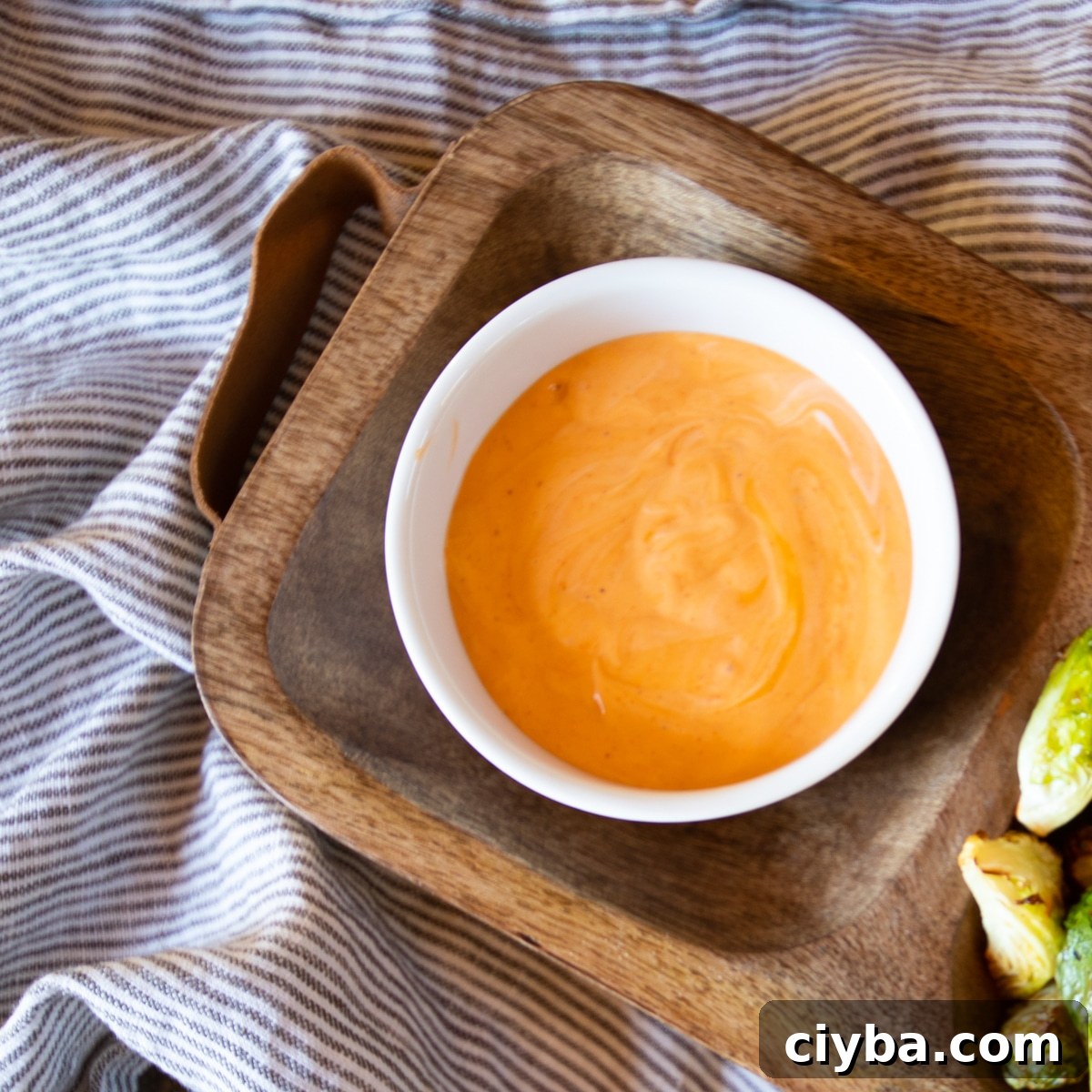 Crispy Air Fryer Brussels Sprouts with Buffalo Ranch Sauce 7 A ramekin of Buffalo Ranch dipping sauce with a few Brussels sprouts.