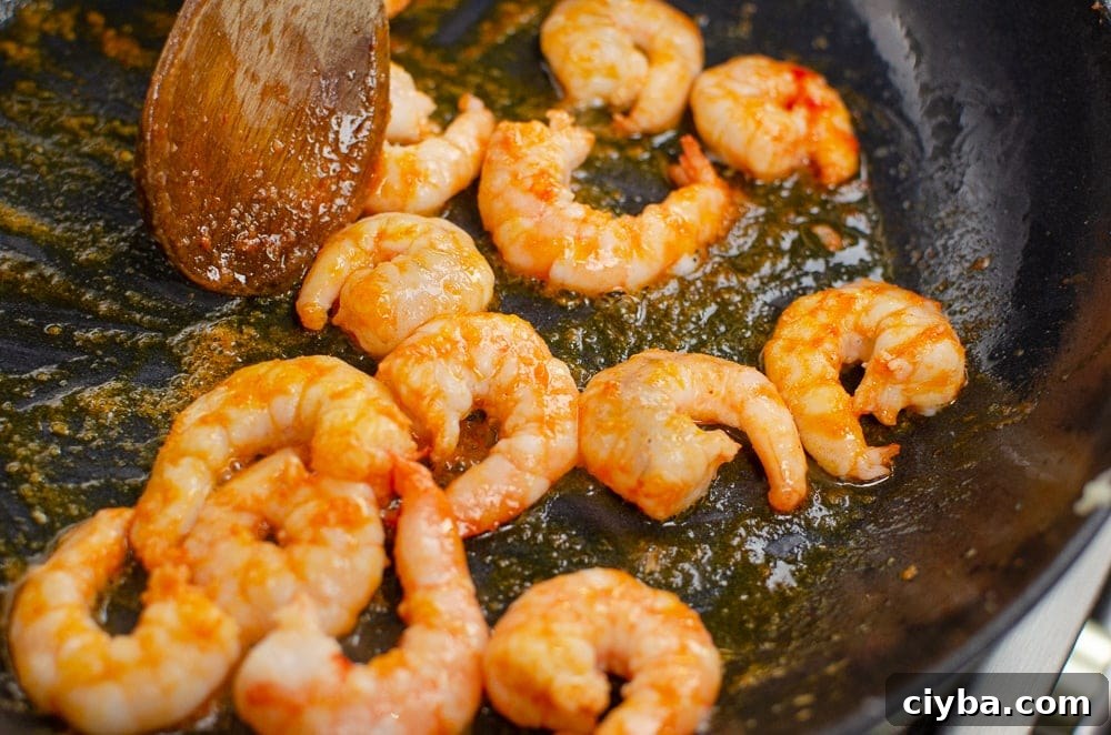 King prawns cooking in a cast iron dish