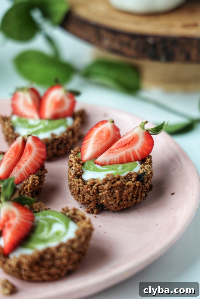 A plate of strawberry matcha granola tarts.