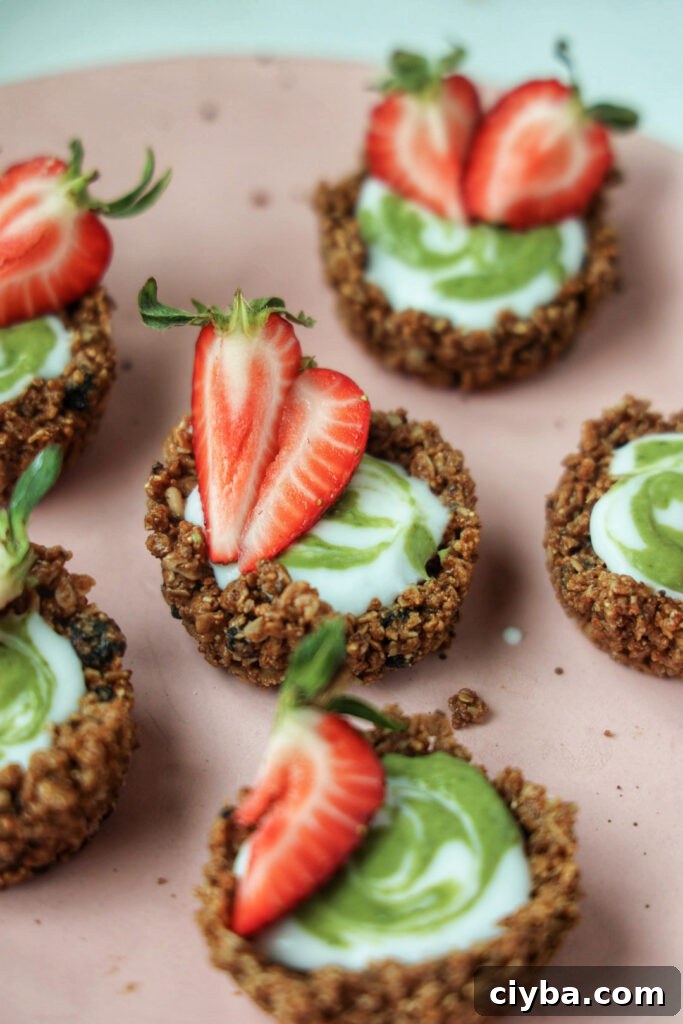 A plate of strawberry matcha granola tarts.
