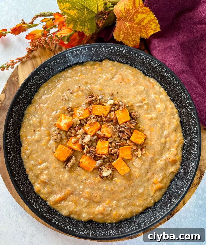 sweet potato oatmeal in a black bowl topped with granola and honey