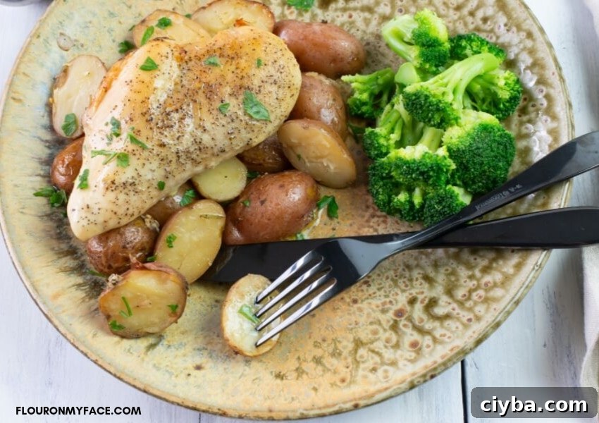 Slow Cooker Chicken and Potatoes with Garlic and Herbs 6 Served chicken and herbed potatoes on a plate.