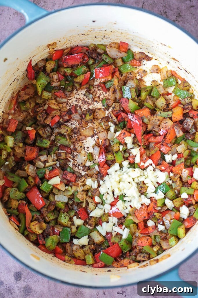 peppers, onions and garlic in a pot for making turkey chili