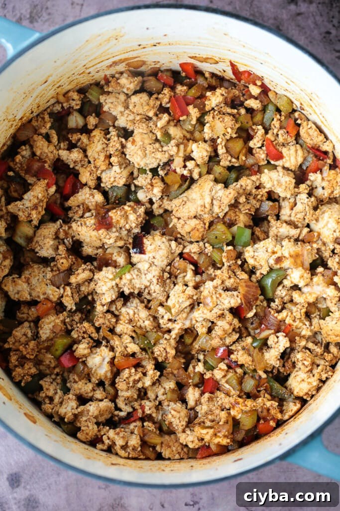 ground turkey, peppers and onions in a pot for chili recipe
