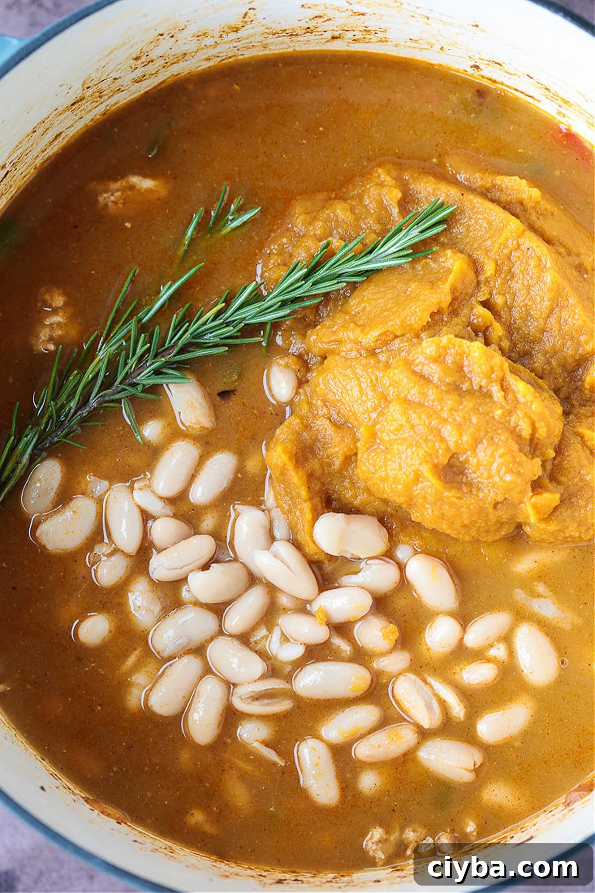 white beans and pumpkin puree in a pot for making pumpkin chili