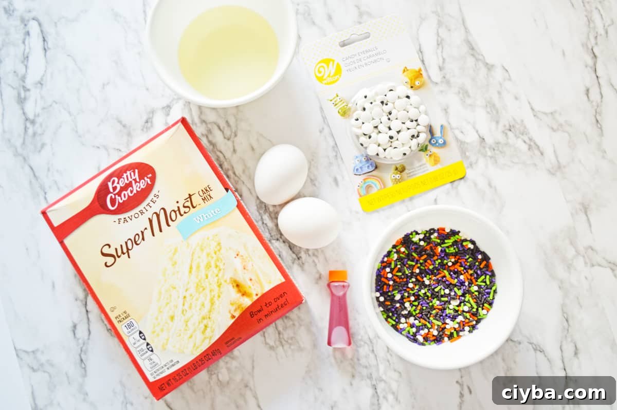 Box of white cake mix, oil, 2 eggs, candy eyes, Halloween sprinkles, and orange food coloring