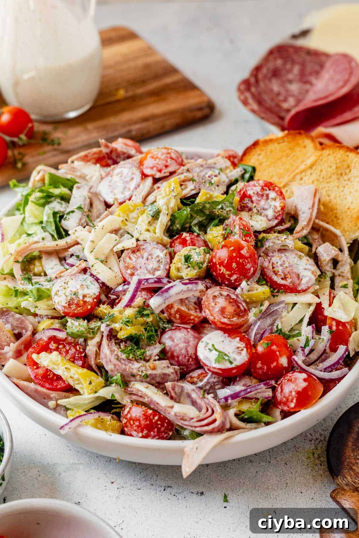 Italian Grinder Salad with Salami, Provolone & Vinaigrette 8 grinder salad recipe in a bowl with creamy italian dressing