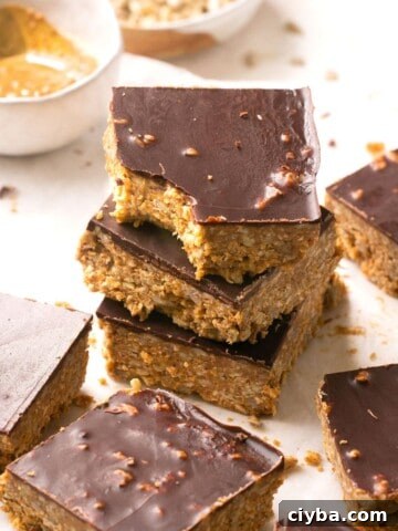 A stack of chocolate almond butter bars and the top one has a bite out of it.