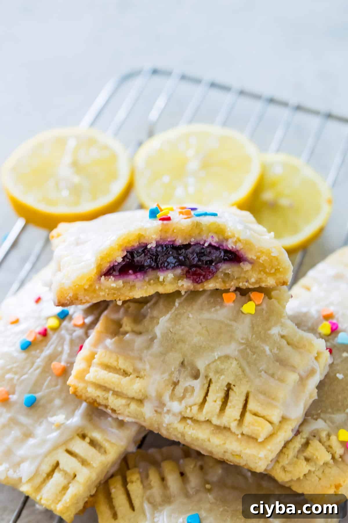 A lemon pop tart that has been broken apart with blueberry jam filling in it.