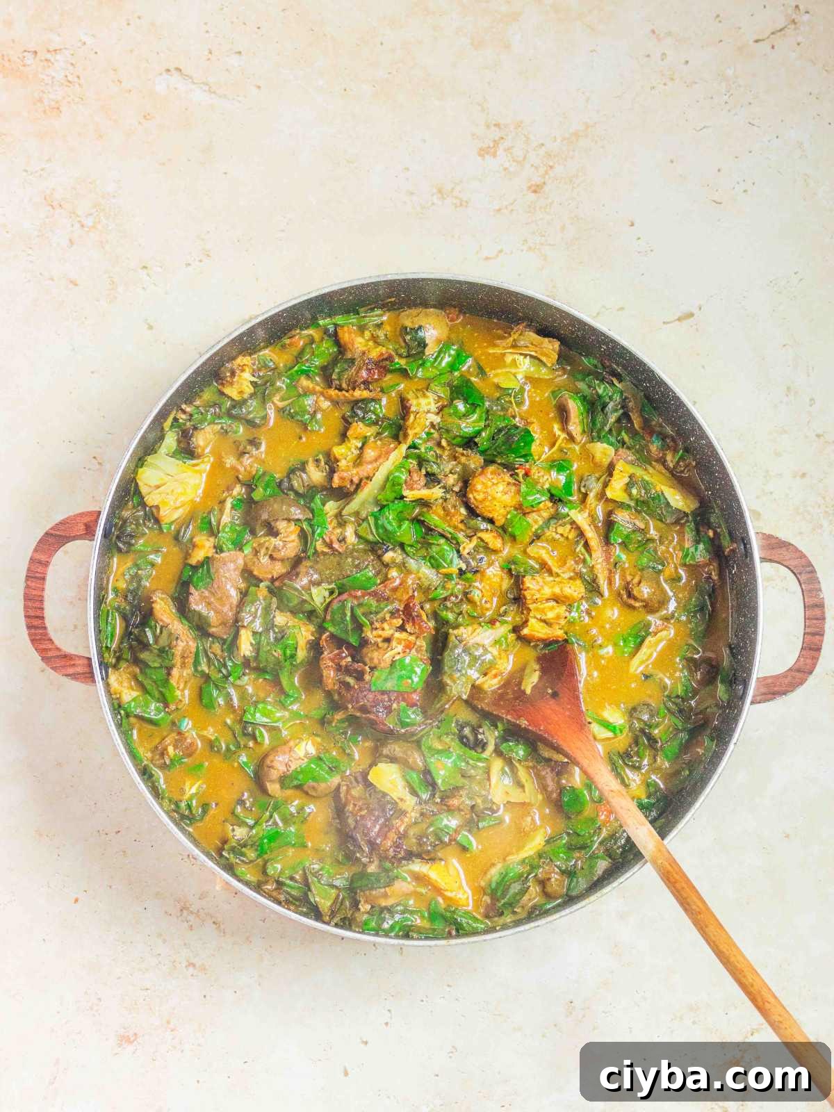 oha pot of soup with a serving spoon.