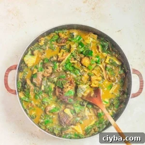 oha pot of soup with a serving spoon.