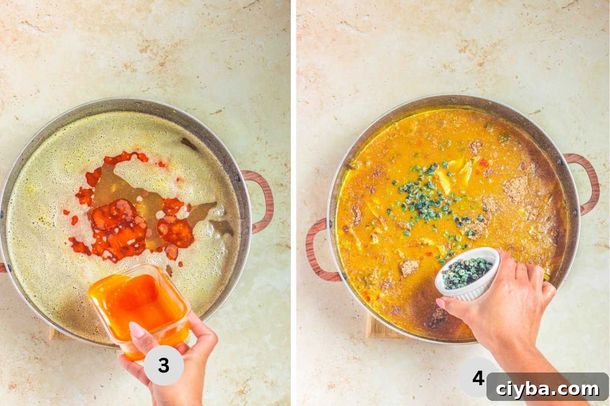 Pouring in palm oil and adding periwinkle in thickened soup.