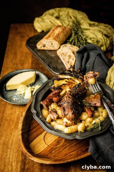 A plate of braised short ribs on a wooden table.