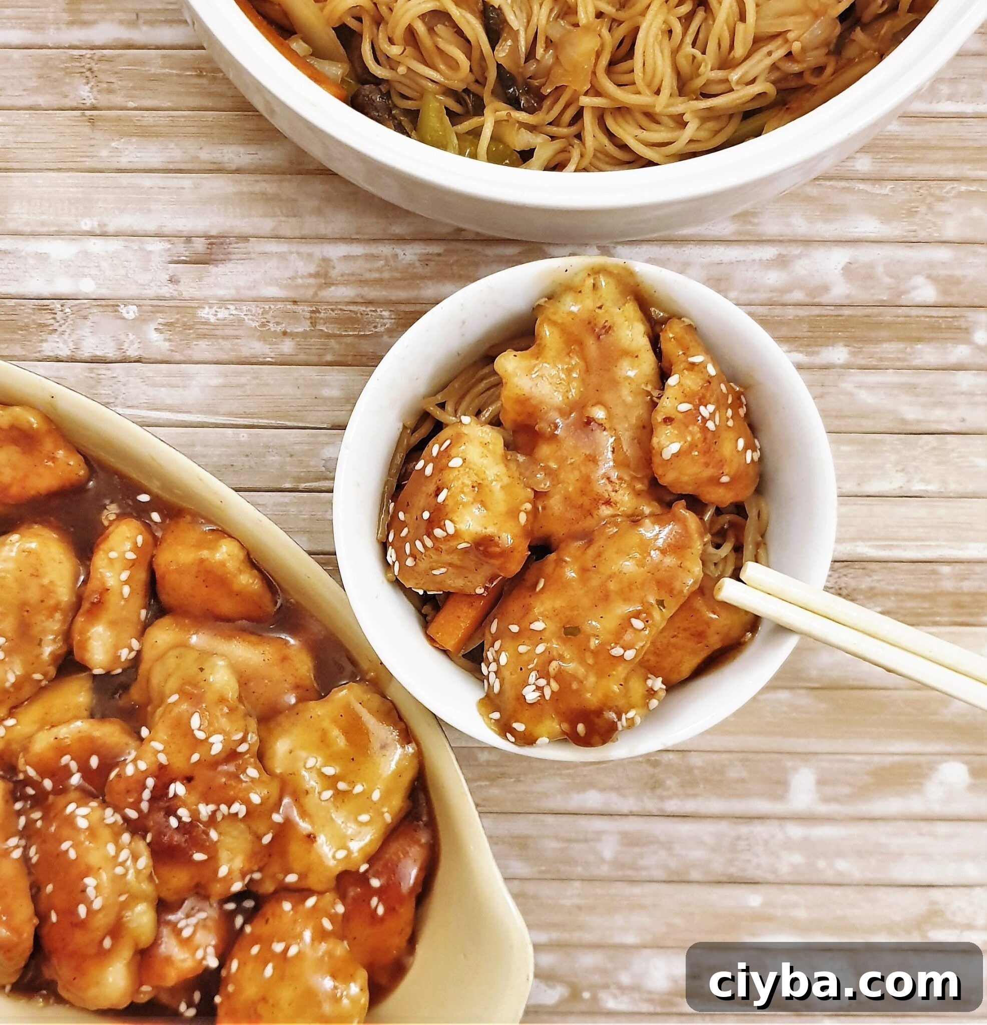 Crispy Sesame Chicken Recipe 7 A dish of sesame chicken with chopsticks.
