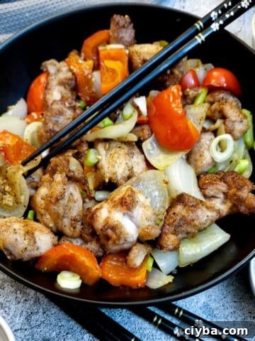 A black serving dish containing salt and pepper chicken.