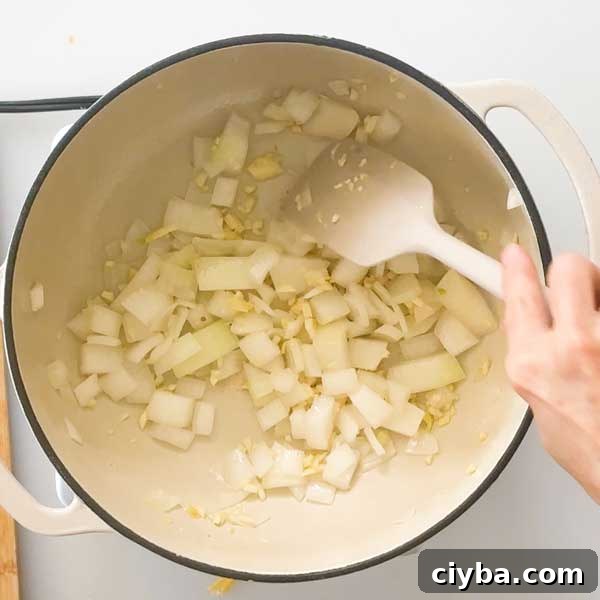 Sauteeing onions and garlic in pot.